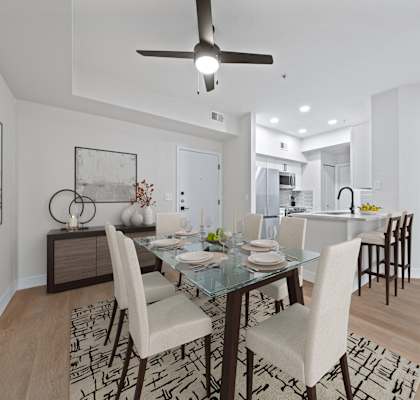 a living room and dining room with a table and chairs